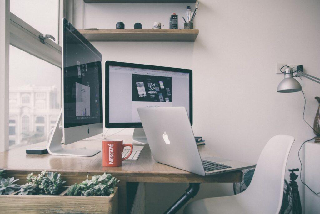 Phoenix Web Services SEO Services office setting with laptops on desk with coffee ready