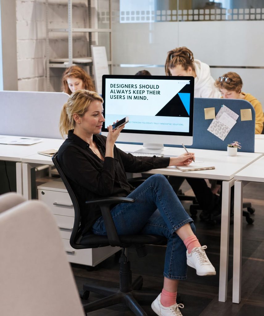 Team working in Phoenix Web Services office with computer screen displaying website information